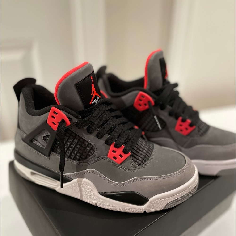 These shoes are Jordan 4 Retro Infrared (GS) in a size 4.5.